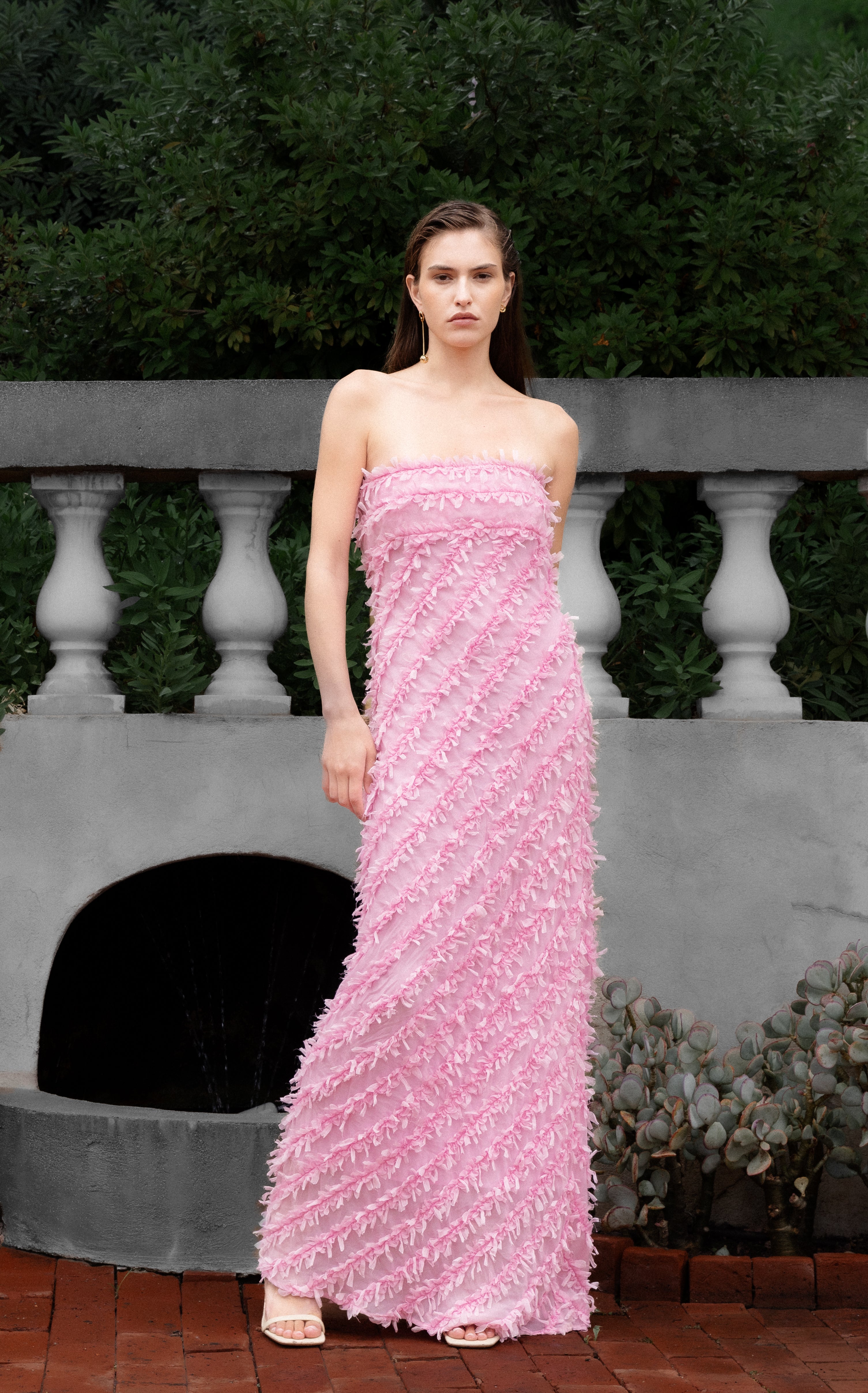 Lady wearing pink strapless ruffled maxi dress