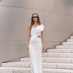 Full-length front view of an off-white strapless crop top featuring a sculptural oversized front knot bow detail.