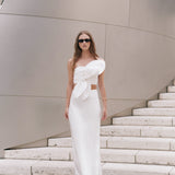 Full-length front view of an off-white strapless crop top featuring a sculptural oversized front knot bow detail.