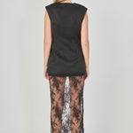 Back view of black tailored vest lace maxi dress featuring a sleeveless tailored vest back and a sheer floral lace skirt.