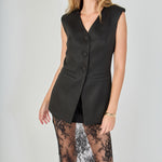 Black tailored vest lace maxi dress featuring a sleeveless V-neckline, button-front closure, flap welt pockets, and a sheer floral lace skirt.