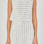 Close-up view of off-white sequin crop top highlighting the high boat neckline, lined mesh bodice, and horizontal sequin stripe detailing.