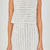 Close-up view of off-white sequin crop top highlighting the high boat neckline, lined mesh bodice, and horizontal sequin stripe detailing.