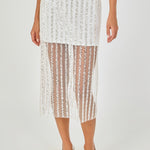 Close-up view of an off-white sequin stripe mesh midi skirt highlighting the sheer mesh hem panel, mini skirt lining, and vertical sequin embroidery.
