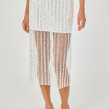 Close-up view of an off-white sequin stripe mesh midi skirt highlighting the sheer mesh hem panel, mini skirt lining, and vertical sequin embroidery.
