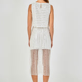 Back view of off-white sequin stripe mesh midi skirt featuring a straight waistline, vertical sequin stripes, and a sheer mesh hem.