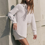Three-quarter view of an ivory sequined mini skirt highlighting the fitted silhouette and grid sequin texture.