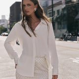 Front view of an ivory sequined mini skirt displaying the high-waisted fit and all-over diamond sequin pattern.