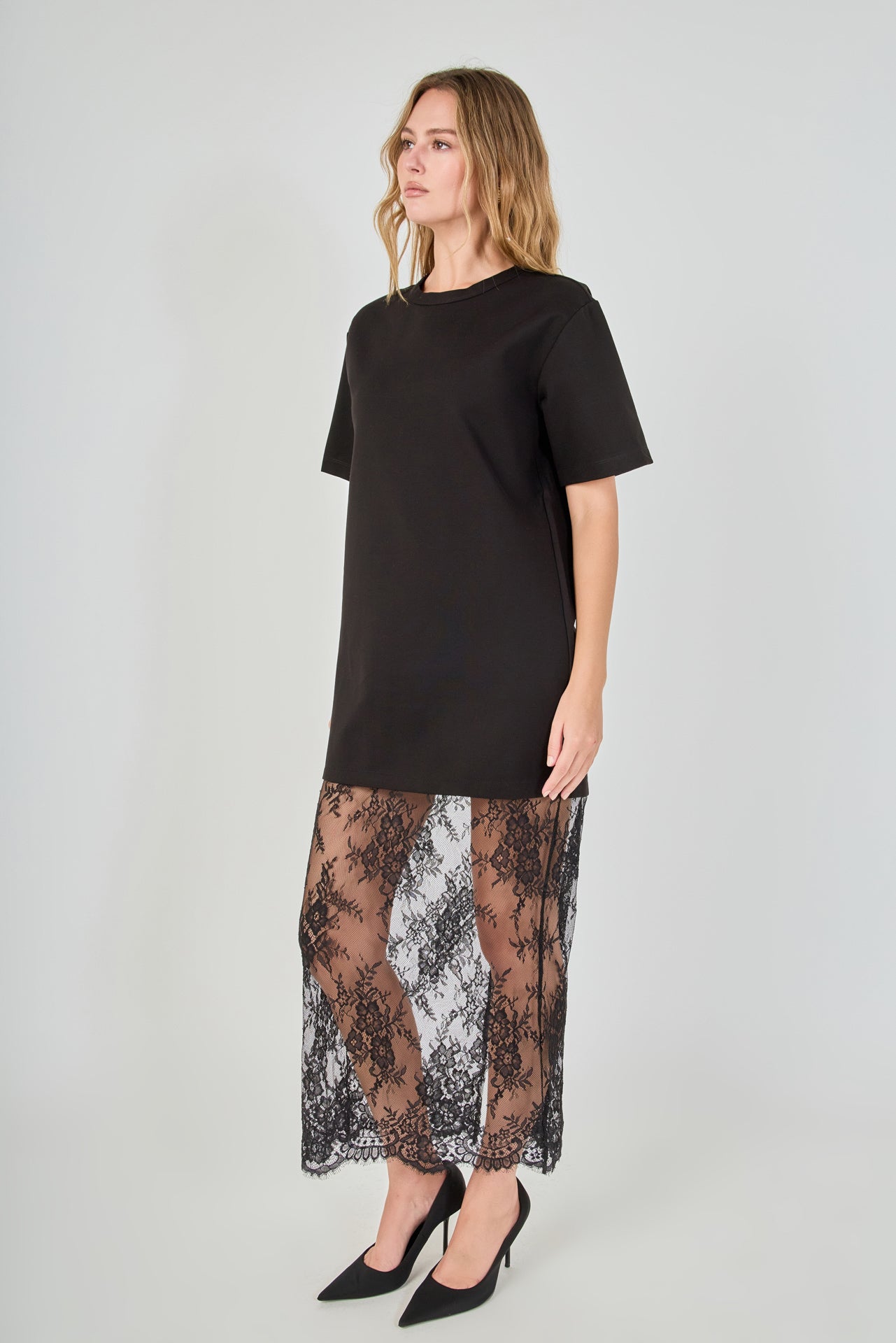 Side view of black mix media maxi dress featuring a short-sleeve boxy t-shirt top and a sheer floral lace skirt.