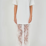 Close-up view of white mix media maxi dress featuring a crewneck short-sleeve t-shirt bodice and sheer floral lace trim.