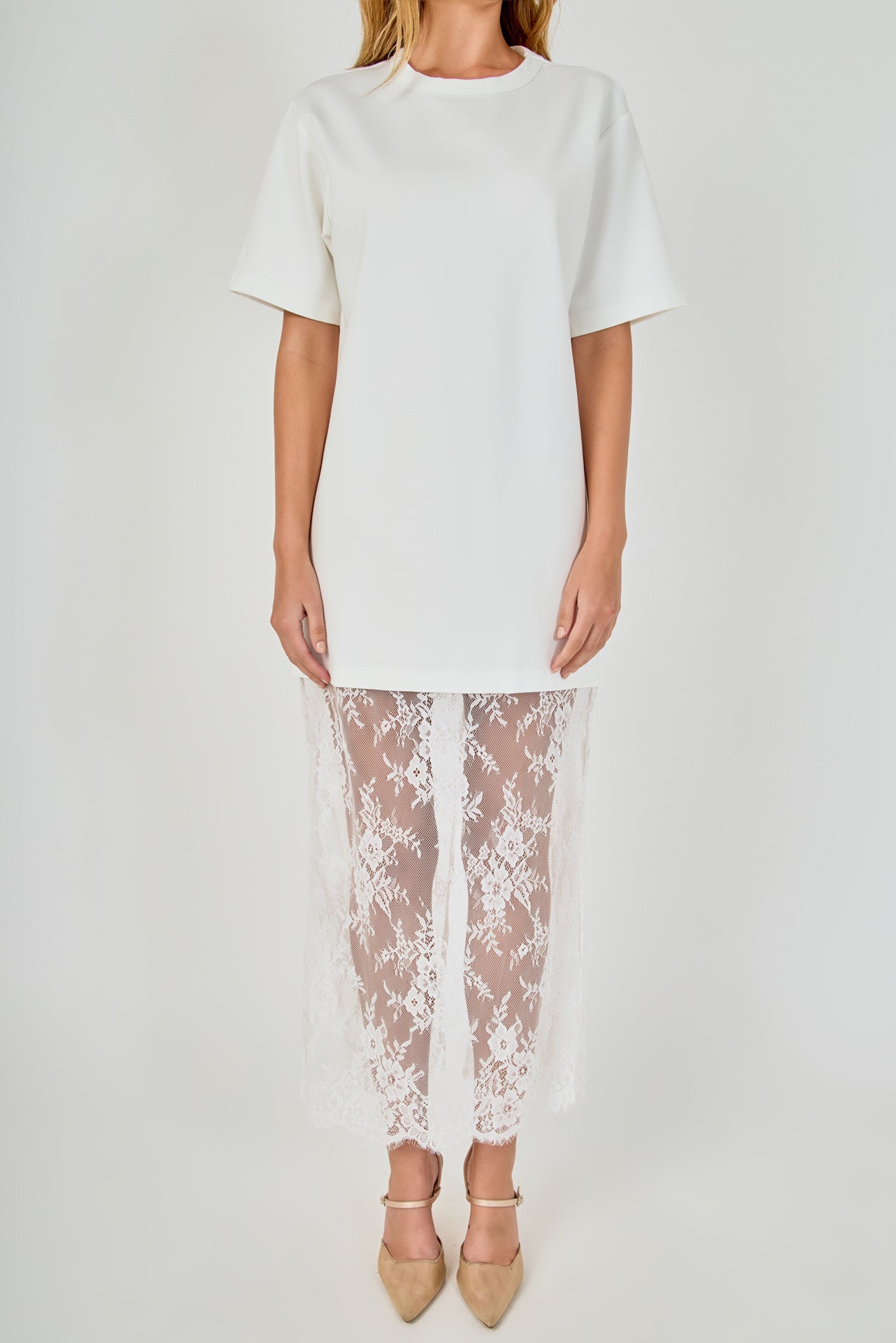 Close-up view of white mix media maxi dress featuring a crewneck short-sleeve t-shirt bodice and sheer floral lace trim.
