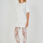 Side view of white mix media maxi dress featuring a short-sleeve boxy t-shirt top and a sheer floral lace skirt.