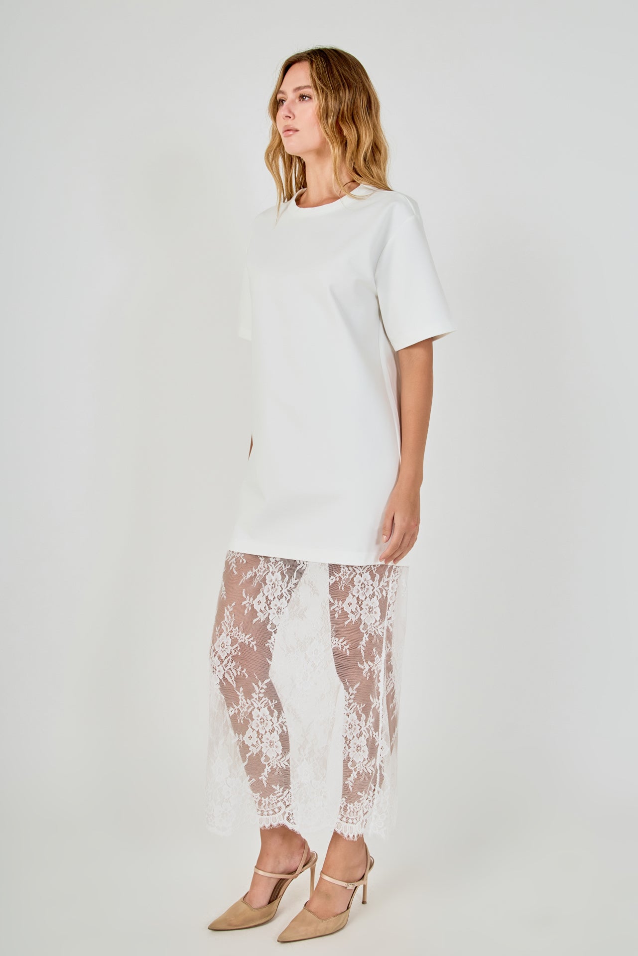 Side view of white mix media maxi dress featuring a short-sleeve boxy t-shirt top and a sheer floral lace skirt.