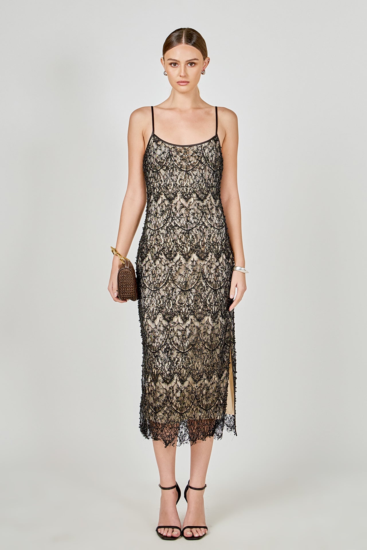 Black beaded lace midi dress featuring thin spaghetti straps, a scoop neckline, nude inner lining, and a scalloped hem with a side slit.