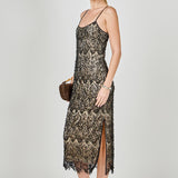 Side view of black beaded lace midi dress featuring thin spaghetti straps, a fitted silhouette, and a side slit.
