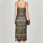 Back view of black beaded lace midi dress featuring thin spaghetti straps, a low scoop back, and a straight hemline.