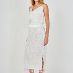 Side view of white high-waisted sequin fringe midi skirt featuring a straight profile and subtle side seam.