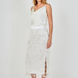 Side view of white high-waisted sequin fringe midi skirt featuring a straight profile and subtle side seam.