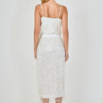 Back view of white high-waisted sequin fringe midi skirt showing the smooth rear waistband and full-length tiered sequin detailing.