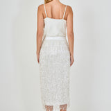 Back view of white high-waisted sequin fringe midi skirt showing the smooth rear waistband and full-length tiered sequin detailing.