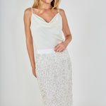Face-forward posed view of white high-waisted sequin fringe midi skirt, showcasing the fit and textured movement.
