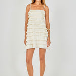 Full-length front view of a cream sleeveless mini dress featuring multi-layered pleated bubble tiers and thin shoulder straps.