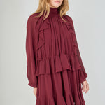 Model in a dynamic, slightly turned e-commerce pose with hands lightly at her sides, emphasizing the movement and voluminous drape of the tiered chiffon ruffled skirt.