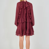 Back view of the deep burgundy chiffon mini dress, showing a clean back bodice with the multi-layered tiered cascading ruffles forming the entire lower skirt.