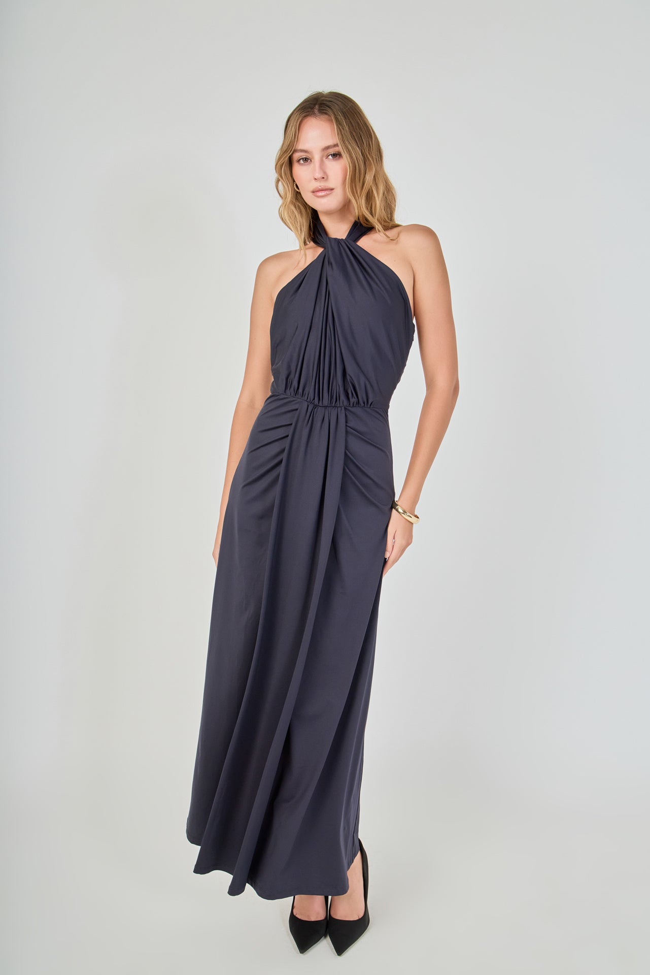 Navy draped halter maxi dress featuring a gathered halter neckline, front waist draping, and a floor-length skirt.