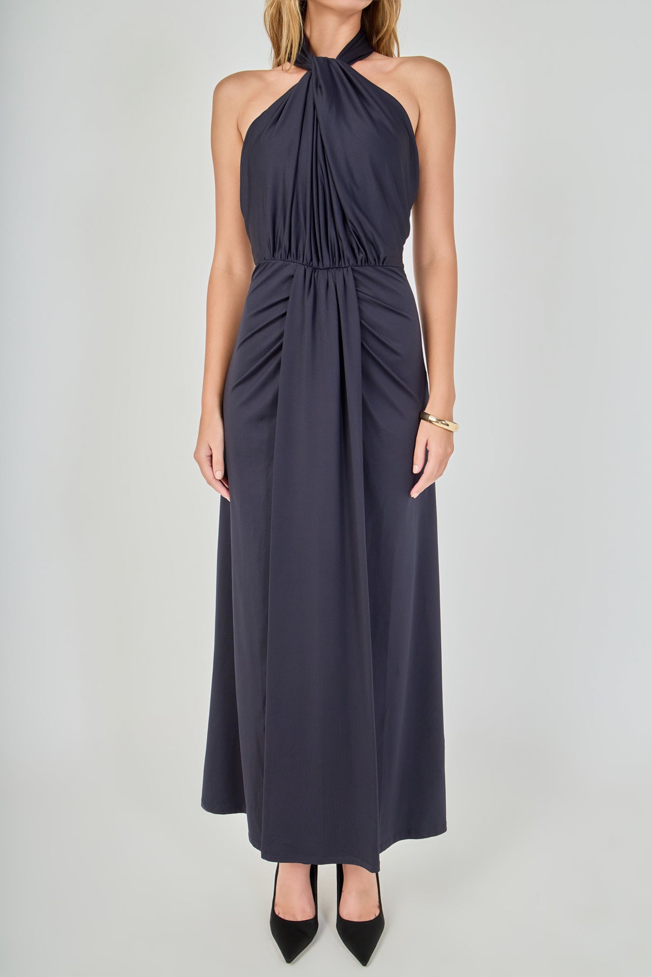 Close-up view of navy draped halter maxi dress featuring a high gathered halter neckline and draped front bodice.