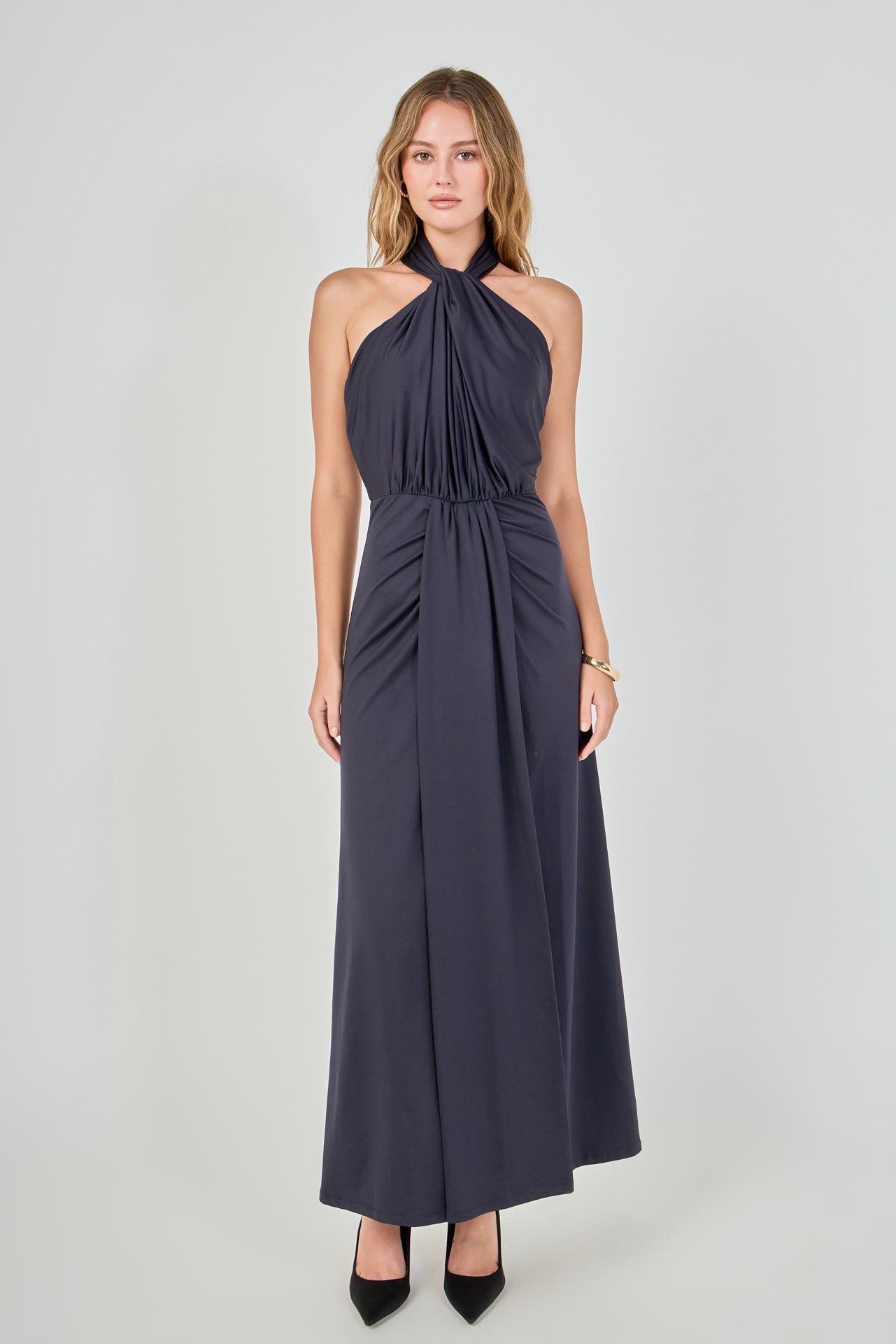 Navy draped halter maxi dress featuring a gathered halter neckline, front waist draping, and a floor-length skirt.