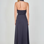 Back view of navy draped halter maxi dress featuring a high halter neck, open back design, and a floor-length hem.