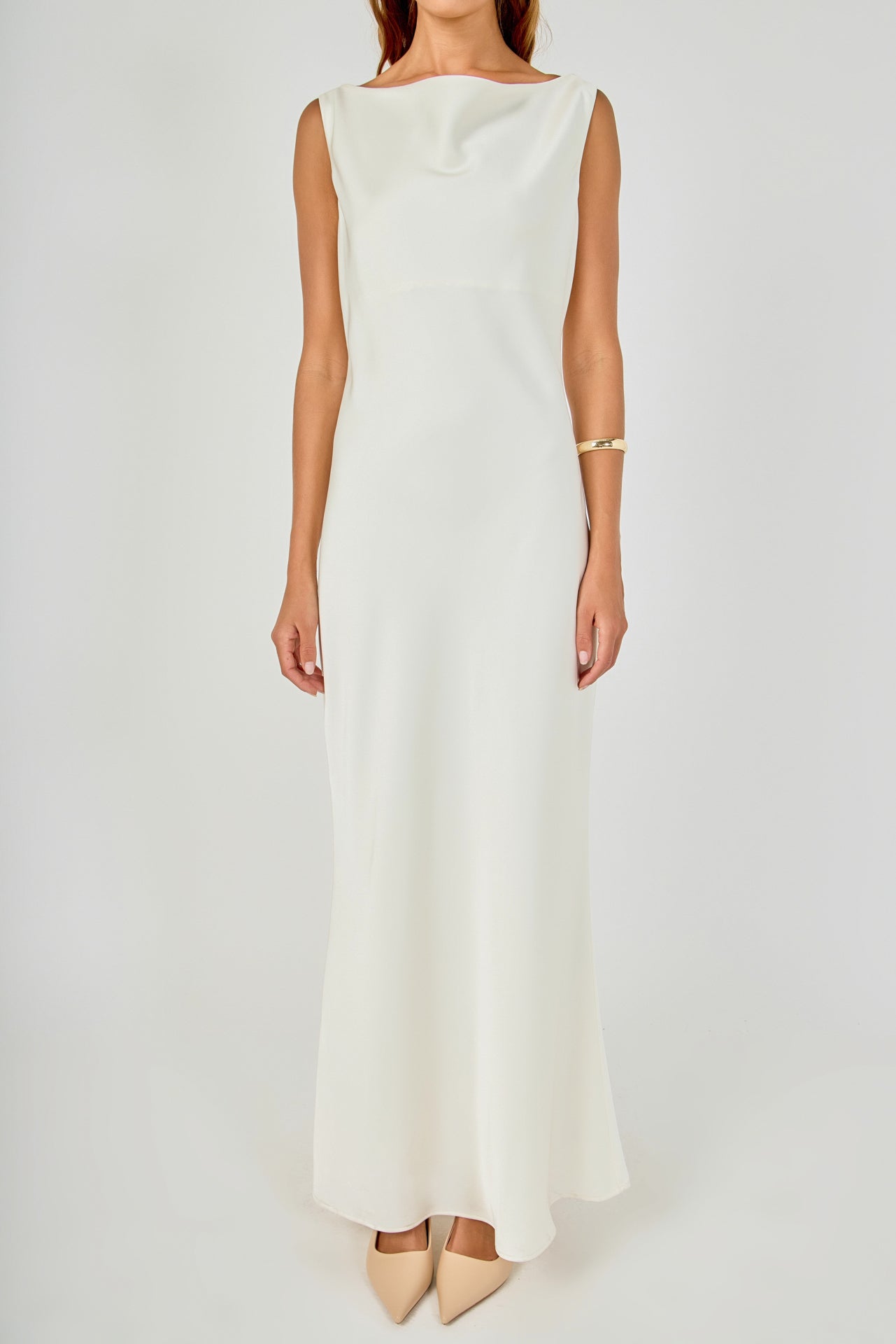 Close-up view of an ivory sleeveless maxi dress highlighting the high draped cowl neckline and refined shoulder seams.