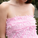 Lady wearing pink strapless ruffled maxi dress