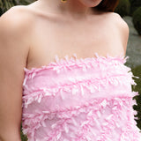Lady wearing pink strapless ruffled maxi dress