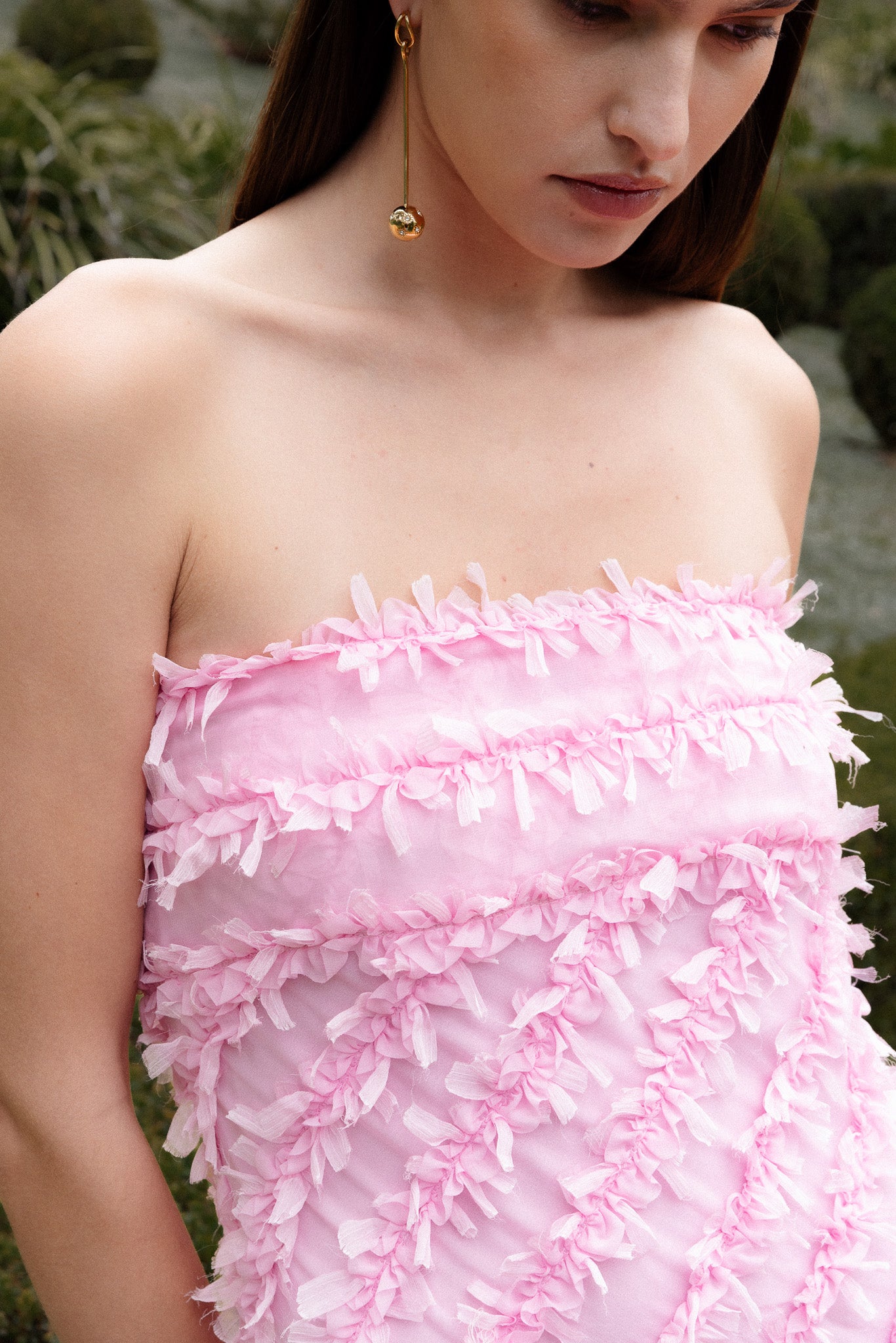 Lady wearing pink strapless ruffled maxi dress