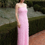 Lady wearing pink strapless ruffled maxi dress