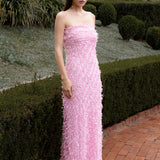 Lady wearing pink strapless ruffled maxi dress