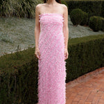 Lady wearing pink strapless ruffled maxi dress