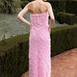 Lady wearing pink strapless ruffled maxi dress