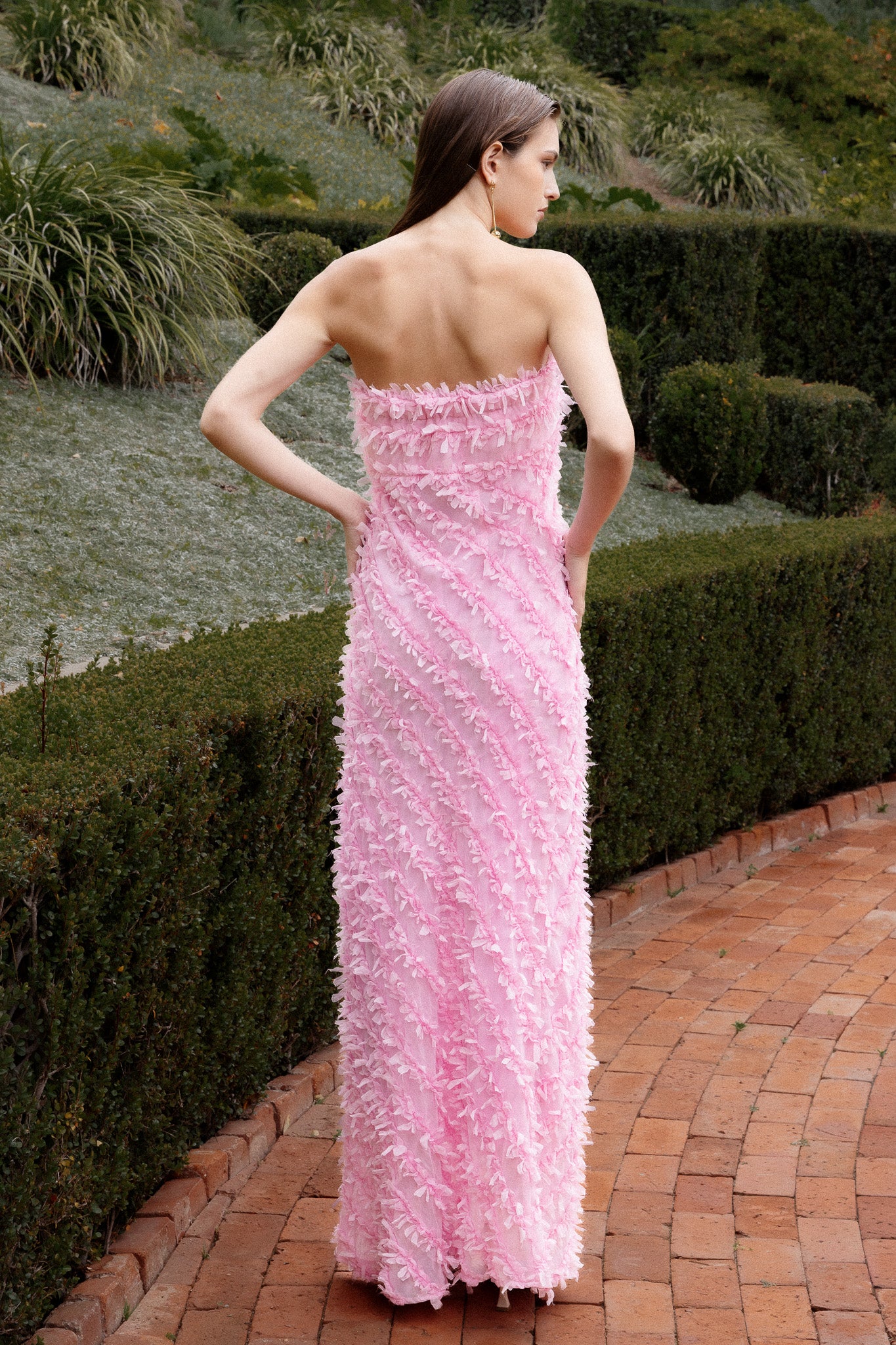 Lady wearing pink strapless ruffled maxi dress