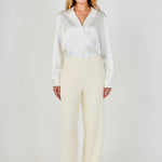 Full-length front view of cream high-waisted wide-leg tweed trousers with a clean waistline and fluid wide-leg silhouette.