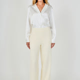 Full-length front view of cream high-waisted wide-leg tweed trousers with a clean waistline and fluid wide-leg silhouette.
