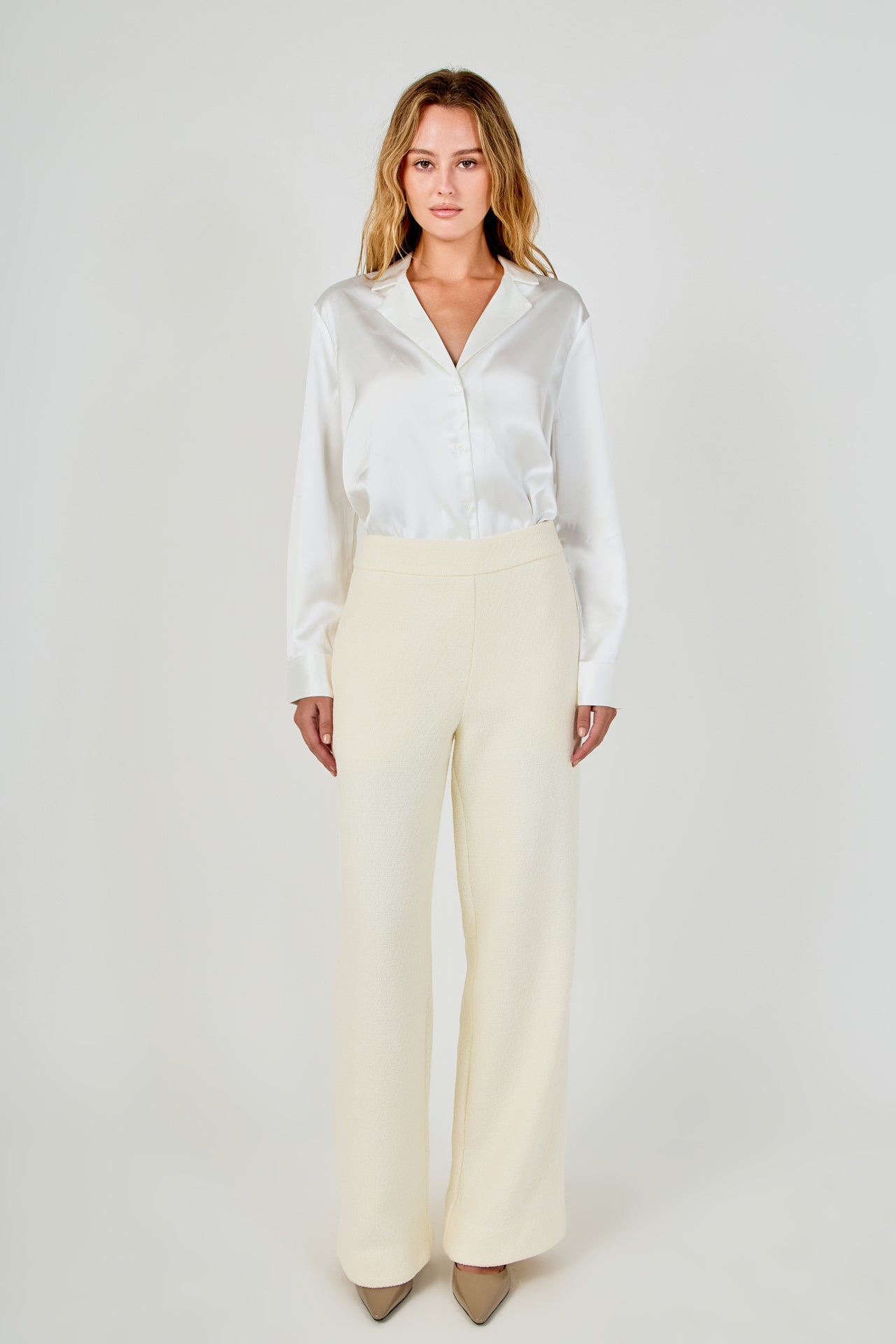 Full-length front view of cream high-waisted wide-leg tweed trousers with a clean waistline and fluid wide-leg silhouette.