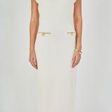 Close-up view of cream sleeveless knit maxi dress highlighting the ribbed crew neckline, cap shoulders, and four faux welt pockets detailed with metallic gold chain and button trim.