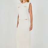 Side profile view of cream sleeveless knit maxi dress displaying the straight drape and structured cap shoulder design.