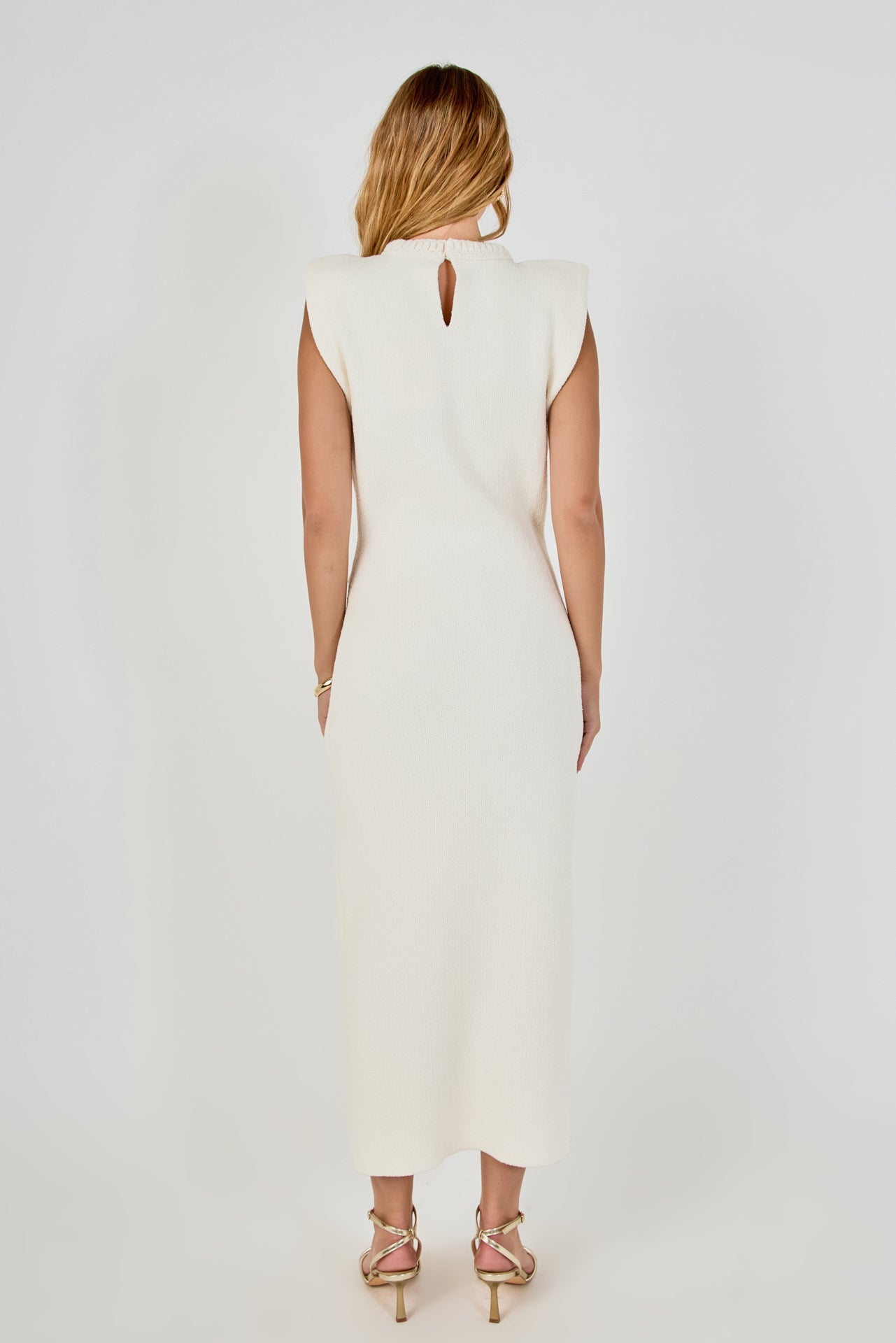 Straight-on rear view of cream sleeveless knit maxi dress featuring a high crew neckline with a subtle keyhole neck cutout.