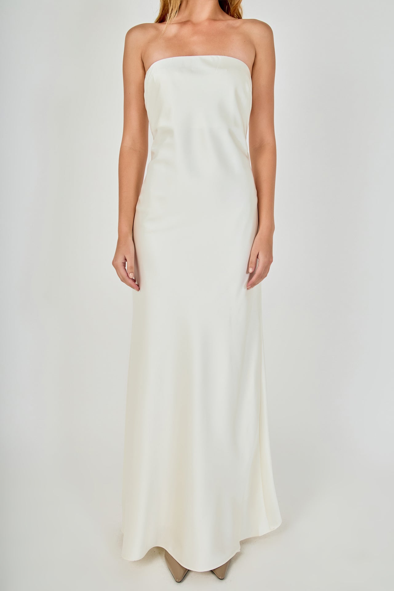 Close-up view of an ivory strapless satin maxi dress highlighting the fitted strapless bodice and smooth satin fabric.