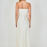 Straight-on rear view of an ivory strapless satin maxi dress displaying the straight back neckline, structured back seams, and fluid skirt fall.