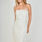 Face-forward posed view of an ivory strapless satin maxi dress featuring a clean straight neckline and fluid column silhouette.